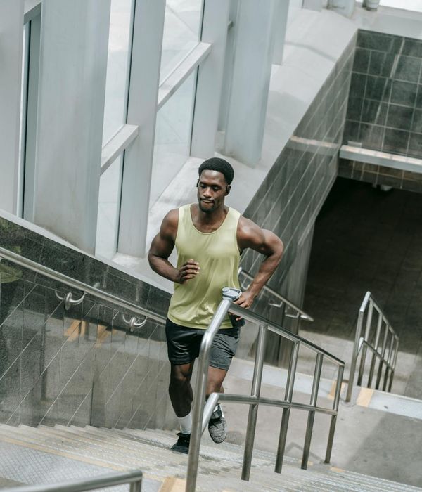 Man performing a functional strength exercise in a bright, modern space.